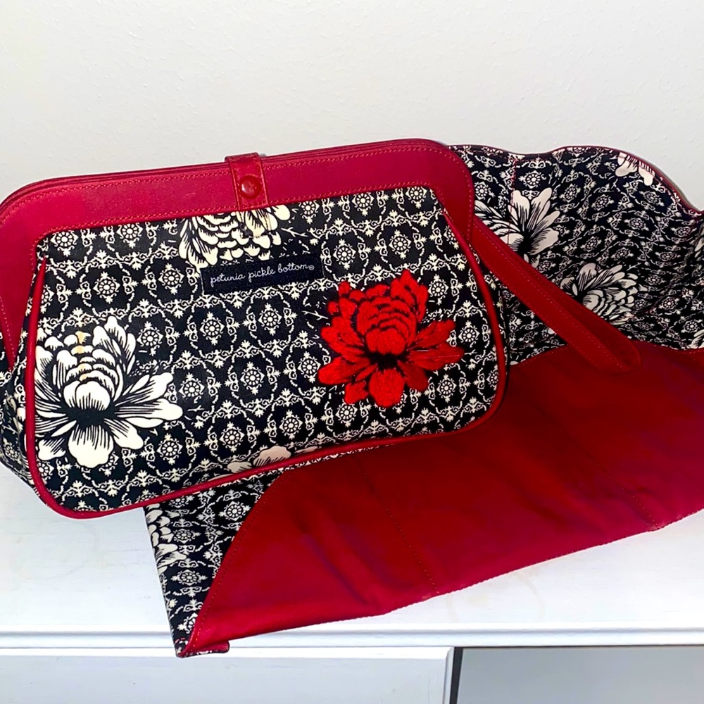 Beautiful baby portable diaper clutch with laying piece.